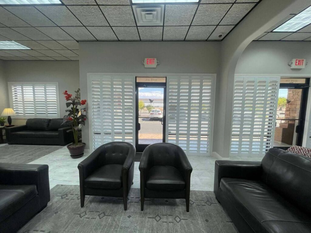 Vertical office shutters and matching window panels provide privacy in this commercial waiting area.