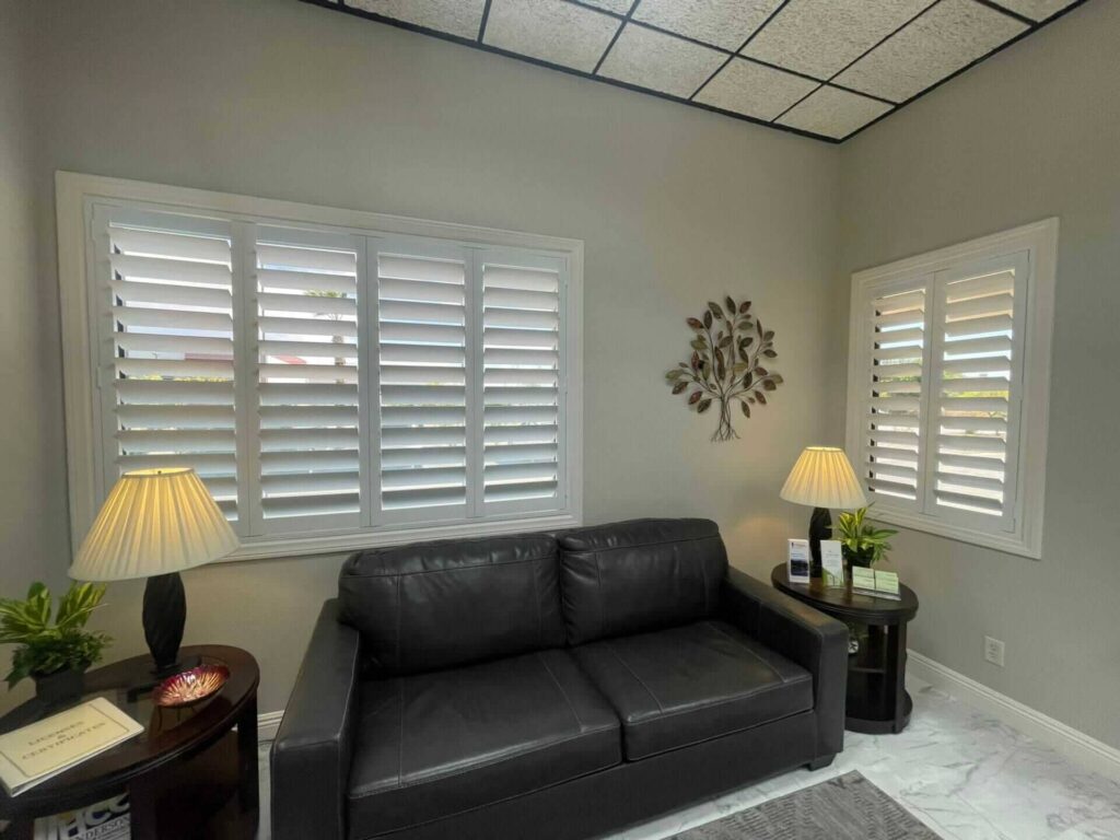 White shutters add a bright, clean look to this small office waiting area.